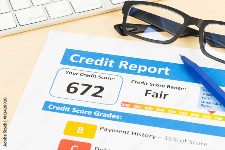 Fair credit score report with pen and keyboard; document is mock