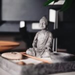 a buddha statue sitting on top of a table