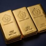 Three gold bars sitting next to each other on a table